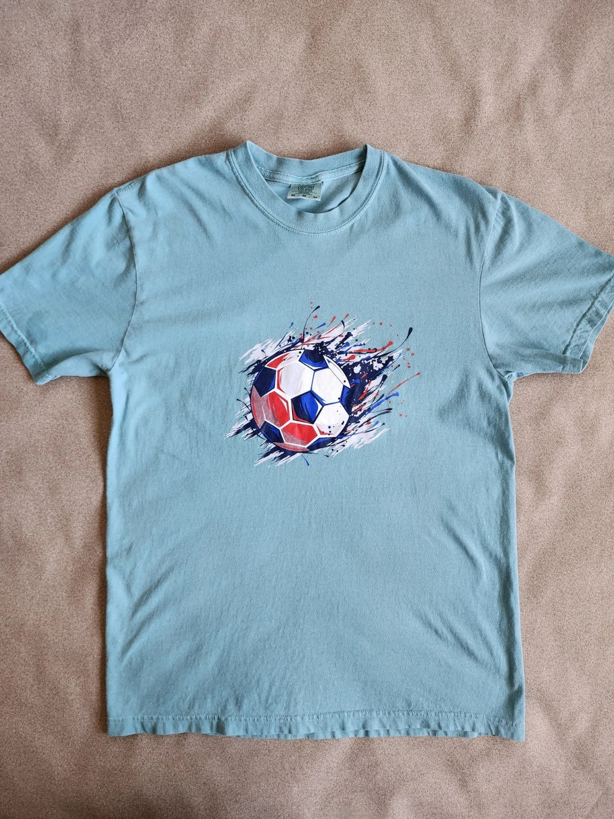 Light green short-sleeve t-shirt with soccer Ball Graphic.  Medium Size Unisex T-shirt, Sweatshirt, Hoodie, Long Sleeve Tee - T-Shirt, Sweatshirt, Hoodie